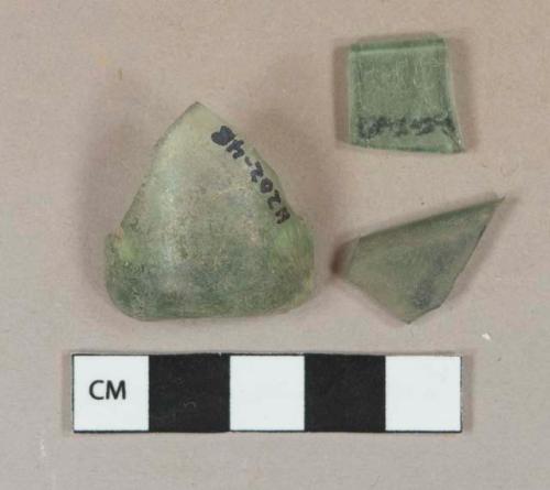 Dark aqua glass vessel base and rim fragments, 1 fragment bottle base with slight push up, no pontil scar