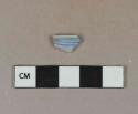 Light blue lead glazed earthenware vessel rim fragment, molded decoration, white or light buff paste