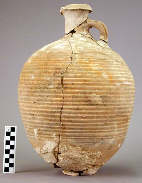 Jug of buff ware with orange-yellow slip, corrugated