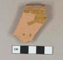 Yellowish brown lead glazed interior redware rim fragment