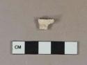 White kaolin pipe bowl foot fragment, stamped "D" on side