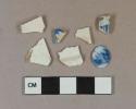 White pearlware vessel base and body fragments, 3 fragments with blue transferprinted decoration, white paste