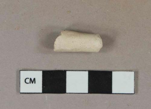 Undecorated white kaolin pipe stem fragment from where joins bowl; 4/64 in bore diameter