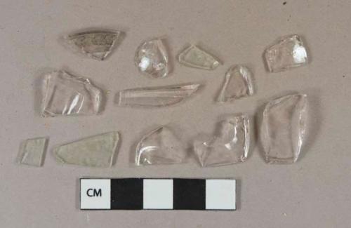 Colorless glass vessel body and rim fragments; 3 colorless flat glass fragments