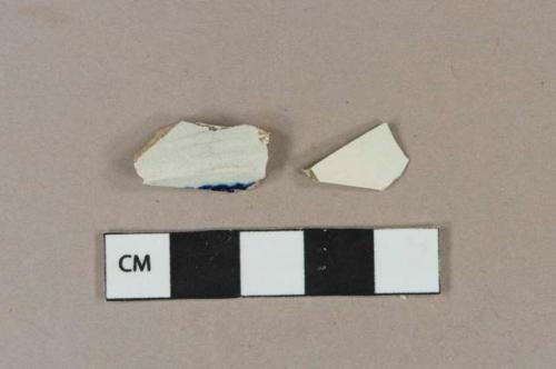 White pearlware vessel body fragments, 1 fragment with blue decoration, light buff paste