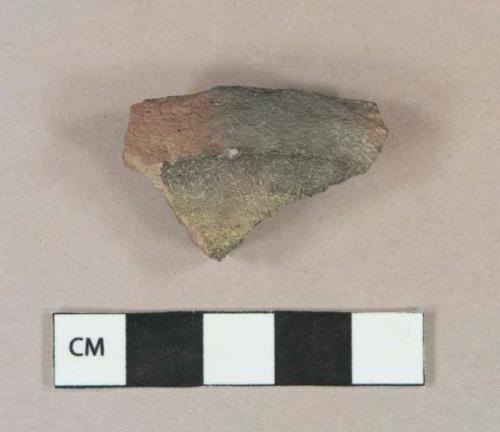 Dark brown lead glazed redware vessel base fragment, heavily burned