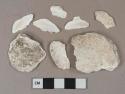 White shell fragments, likely oyster, heavily degraded