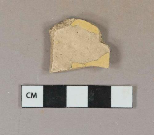 Yellow lead glazed earthenware vessel body fragment, buff paste