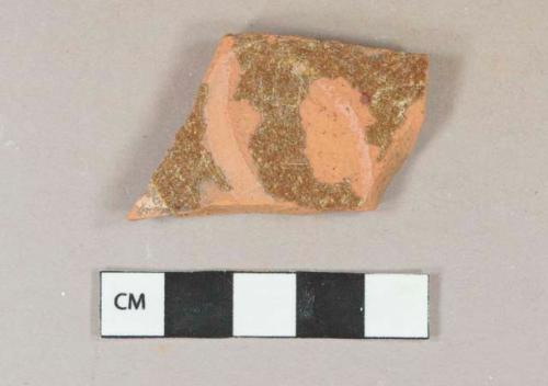 Brown lead glazed redware vessel body fragment, slip decorated