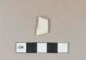 White kaolin pipe bowl fragment with partial stamp of cartouche with "[..]D"