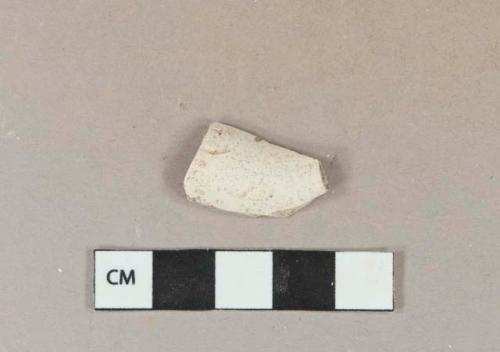 White kaolin pipe bowl fragment with partial cartouche stamp