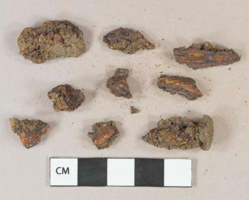 Ferrous nail fragments, heavily corroded, 1 fragment adhered to stone pebble