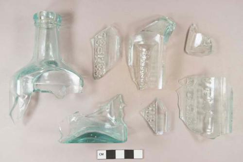 Glass, mold made, bottle, medicinal; light aqua, rectangular, fragments, paneled with embossed lettering on each side, "SARSA..." ; "COMPOUND..." / "...T." / "...ELL / S.U.S.A.", Hood's Sarsaparilla Compound, Lowell, MA