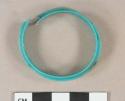 Teal blue plastic beverage bottle seal fragment