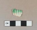 Green shell-edged pearlware vessel rim fragment, light buff paste