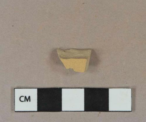 Yellow lead glazed refined earthenware vessel body fragment, buff paste