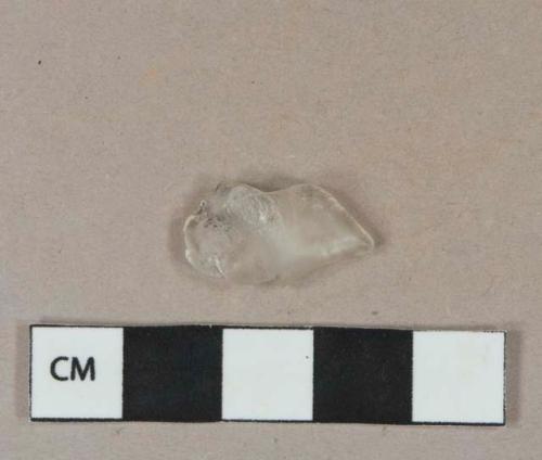 Colorless glass fragment, melted, likely vessel glass