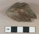Mudstone fragment with ferrous staining, possibly architectural