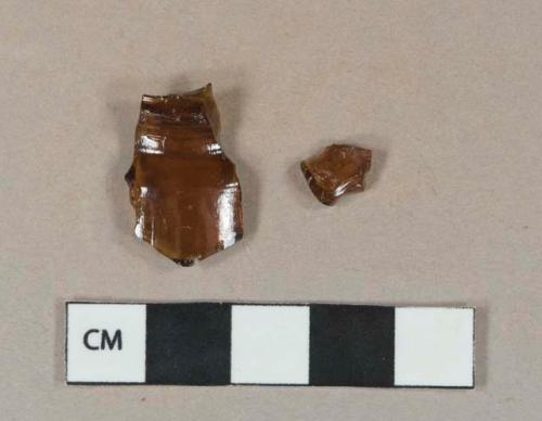 Amber glass vessel fragments, possible bottle shoulder and body fragments