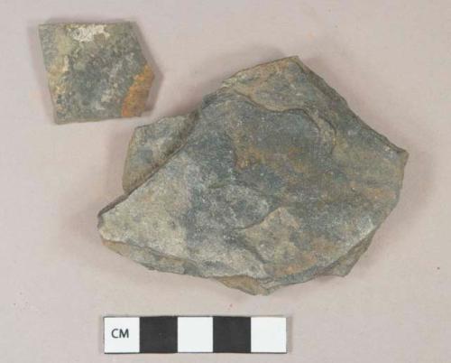Mudstone fragments, possibly architectural, ferrous staining on surface