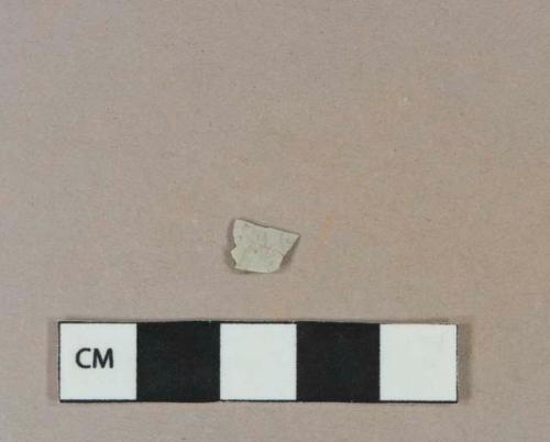 Undecorated whiteware vessel body fragment, white paste, burned