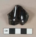 Dark olive green vessel glass body fragment, likely bottle glass