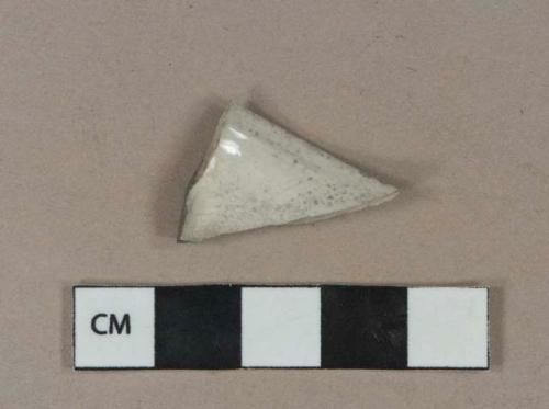 Undecorated whiteware vessel rim fragment, white paste, heavily burned