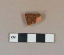 Reddish brown lead glazed redware vessel body fragment