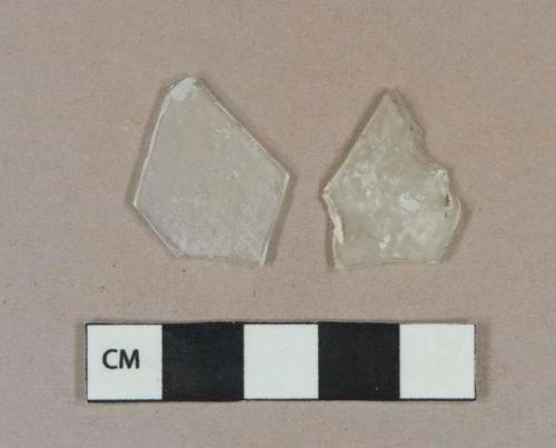 Colorless flat glass fragments, weathered