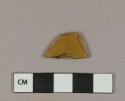 Yellow glass vessel body fragment