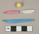 Plastic fragments, 1 white fragment, 1 yellow ball, 1 blue fragment, and 1 pink fragment