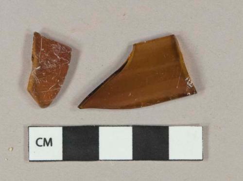 Amber vessel glass body fragments, likely bottle