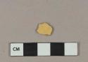 Undecorated yellow lead glazed earthenware vessel body fragment, buff paste