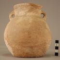 Pottery vessel with comb band on throat