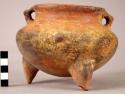 Red tripod pottery vessel with fragment of rim missing