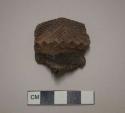 Ceramic rim sherd, rim is flat, incised designs on exterior