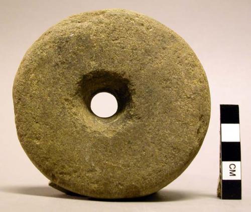 Stone disc implement with hole in center