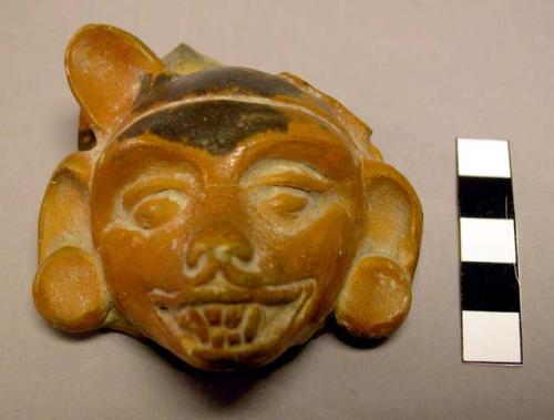 Red pottery head - fragment from a plumbate jar