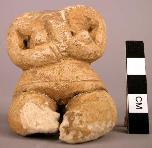 White pottery female figurine. Headless, seated