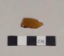 Embossed amber bottle glass fragment