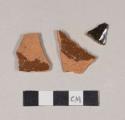 Undecorated lead glazed redware body sherds; two sherds crossmend