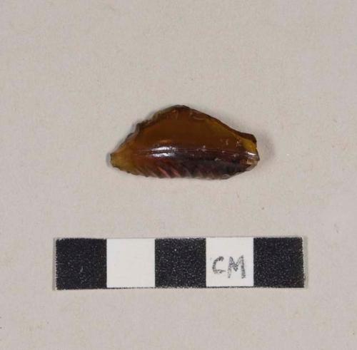 Molded and embossed amber bottle glass base fragment