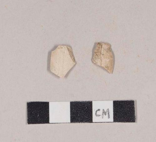 Unsmoked pipe bowl fragments; one has possible incised decoration