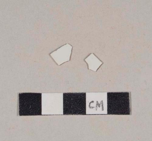 Undecorated pearlware body sherds; two sherds crossmend