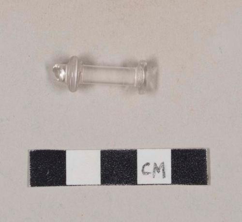 Molded colorless glass object fragment, likely a fragment of a syringe plunger