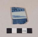 Blue hand painted porcelain body sherd, with rough orange reverse surface; possible tile sherd