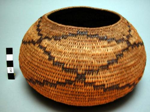 Oval-shaped basket with dark brown design