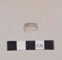 Curved colorless glass fragment with folded rim