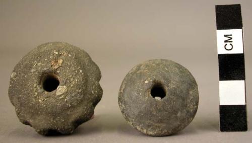 2 clay beads or spindle whorls