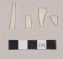 White plastic fragments; one may be a fork tine
